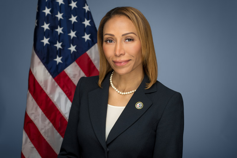 Rachel Williams ANC campaign headshot photo with American flag in background.